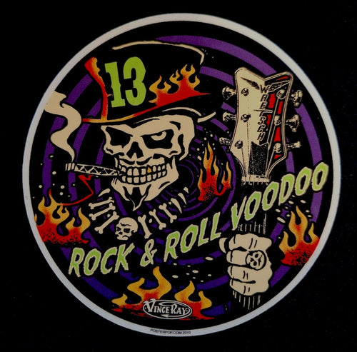Circular design with a skull, guitar, and flames on a black background